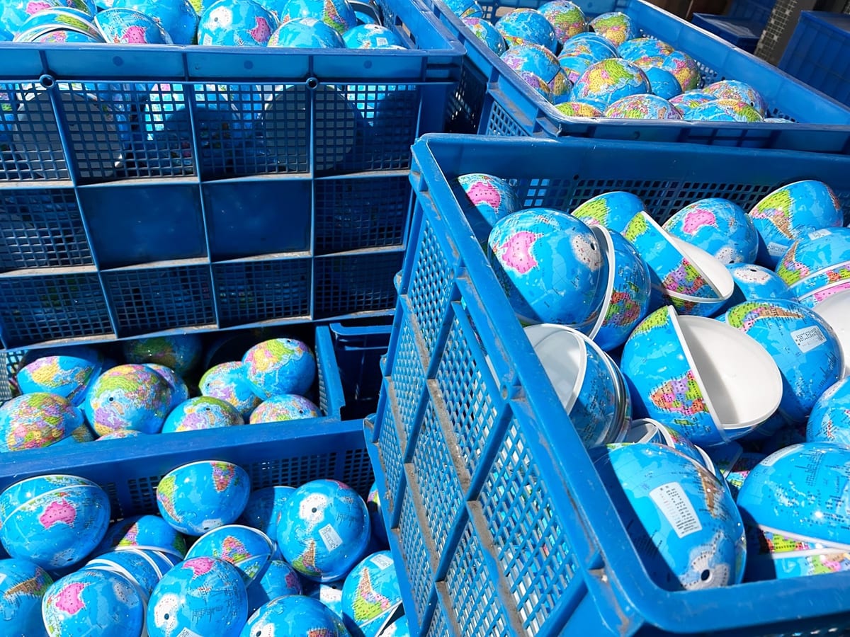 Semi-finished globe shells in crates awaiting assembly